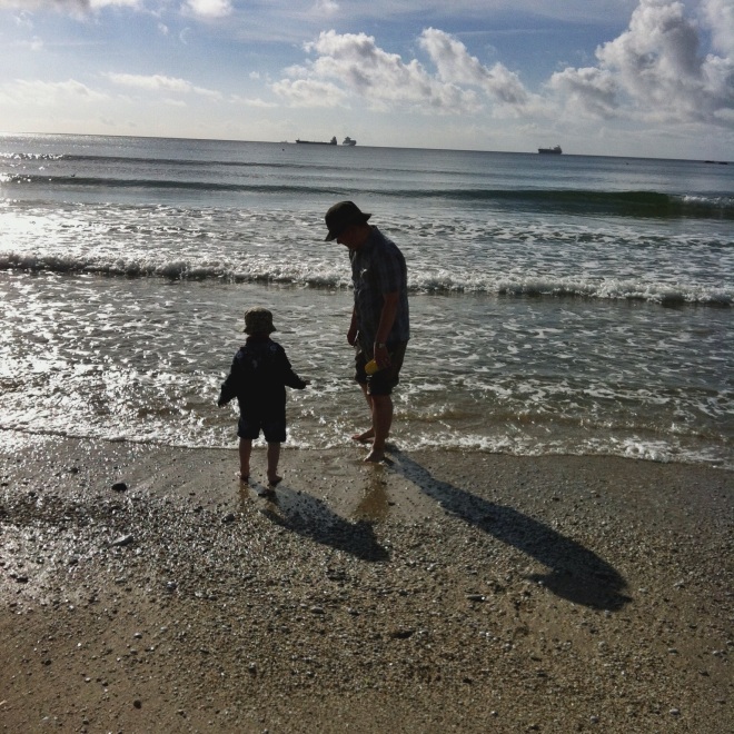 Father and son paddling in the sea